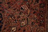Vintage Qashqai rug detail showing madder root, navy, ivory geometric and floral motifs.