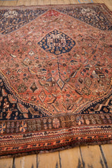 Vintage Qashqai carpet's geometric end border with dark brown, rust, and tangerine motifs.