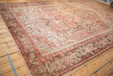 Faded floral field, stepped corner spandrel, and turtle samovar border of a vintage Mehrivan carpet.