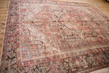 Distressed Mehrivan carpet border featuring faded raspberry, slate blue, and brown turtle patterns.
