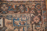 Chocolate brown and sapphire blue geometric border on a short-piled vintage Mehrivan carpet corner.