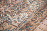 Angled close-up of the even, short pile featuring geometric blossoms and palmettes.