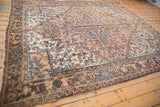 Angled view of the vintage Mehrivan carpet's corner and complex chocolate brown border.