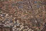 Close view of stepped medallions and floral motifs in dusty blush, sapphire blue, and brown.