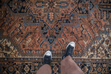 Dusty terra cotta Persian Mehrivan carpet with serrated palmettes, vines, and turtle samovar border.