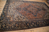 Vintage Mehrivan carpet's navy border, turtle samovar motif, and restored side selvage.