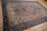 Navy and bronze turtle samovar border with dusty terra cotta field on a vintage Mehrivan carpet.