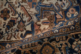 Textured pile of a vintage Persian Mehrivan carpet, displaying dusty sandalwood, terra cotta, and sapphire blue motifs.