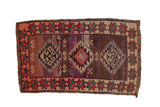 Distressed Kars rug with triple medallions, starburst border, and abrash tones.