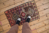Distressed vintage Kars rug mat with central geometric medallion, charming plum and pink abrash.