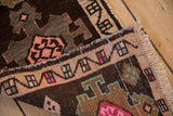 Secured side cord selvage and low hand-knotted pile of a vintage distressed Kars rug.
