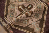 A folded view showing the even wear and low, hand-knotted pile of a distressed vintage Kars rug.
