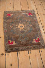 Distressed Turkish Kars rug corner with red and bronze geometric spandrel pattern.