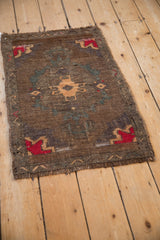 Distressed vintage Kars rug with abrashed bronze, aubergine, and sand geometric motifs.