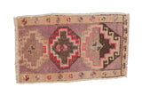 Vintage distressed Kars rug mat with a triple stepped medallion in mauve, brown, and dusty red tones.