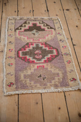 Angled perspective of a distressed Kars rug with mauve and brown geometric medallions.