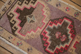 Detailed view of the low-pile texture on a distressed Kars rug with mauve and brown geometric patterns.