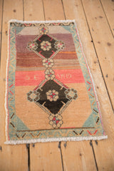 Abrashed pink and mauve main field, dark floral medallion, vintage Kars rug.