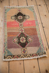 Distressed Kars rug showing lower floral medallion, vibrant abrashed color bands, and vine border.