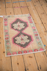 Intact side cord and worn floral border of a distressed Turkish Kars rug.