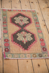 Distressed Kars rug mat with two interconnected charcoal medallions outlined in vibrant fuchsia.
