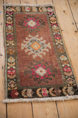 Dark charcoal border of a vintage Kars rug with geometric hook and latch tendrils.