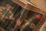 Distressed short pile of Turkish Kars rug, geometric patterns, raspberry florals, serrated tangerine border.