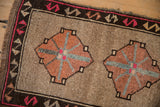 Textural distressed pile of a vintage Kars rug's geometric blossom medallion and border.