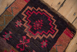 Distressed Kars rug featuring geometric stepped medallion in fuchsia and dusty gold.