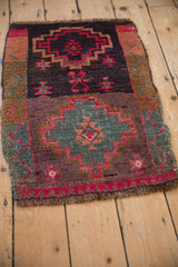 Fuchsia, dusty plum, and slate blue stepped medallion with chevron border and abrashed ground.