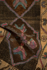 Distressed vintage Kars rug's varied pile, dusty mauve and slate blue primitive florals.