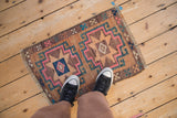 Distressed Kars square rug features pink, teal geometric gul starburst medallion.