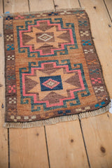 Distressed pink, teal, and sand geometric motifs in the vintage Kars rug corner.