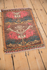 Perspective view of a distressed Kars rug mat highlighting its low pile and rose design motifs.