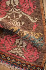 Close-up on the distressed hand-knotted pile showing its low, even wear.