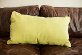 Close-up of the muted lime green corduroy fabric texture on the oversize pillow.
