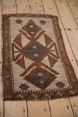 Angled view of a vintage Kars rug showcasing its distressed texture and earthy geometric medallion.