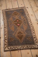 Vintage Kars rug, geometric border with meandering vine and blossom, charcoal and sand tones.