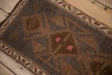 Vintage Distressed Kars rug with geometric blossom and vine borders in charcoal, bronze, and pink.