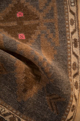 Close-up of distressed Kars rug showing even wear, geometric brown and pink patterns.