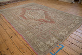 Distressed Oushak carpet, faded dusty rose field, stepped medallion with floral blossoms.