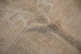 Dark wefting and machine-bound edge on the back of a distressed vintage Oushak rug.