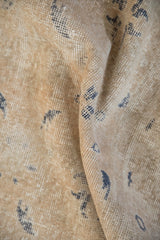 Distressed pile of the vintage Turkish Sparta carpet, showing worn beige and dusty navy motifs.