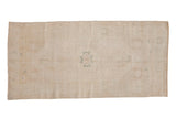 Vintage distressed Oushak runner with a stepped center medallion in soft platinum and pale sea foam green.
