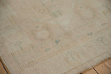 Textured close-up of a distressed Oushak runner with a low pile and time-softened wear.