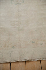 Detailed texture of a distressed Oushak rug showing even wear across the knot heads.