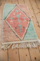 Angled view of the Moroccan rug mat showing its plush, even pile and ivory fringe.