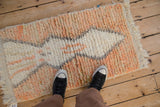 Top-down view of the thick, plush pile of a Moroccan rug mat shown for scale.