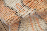 Thick, even pile and soft hand-knotted texture of a Moroccan wool rug mat.