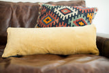 Mustard yellow velvet fabric backing of the unique long pillow.